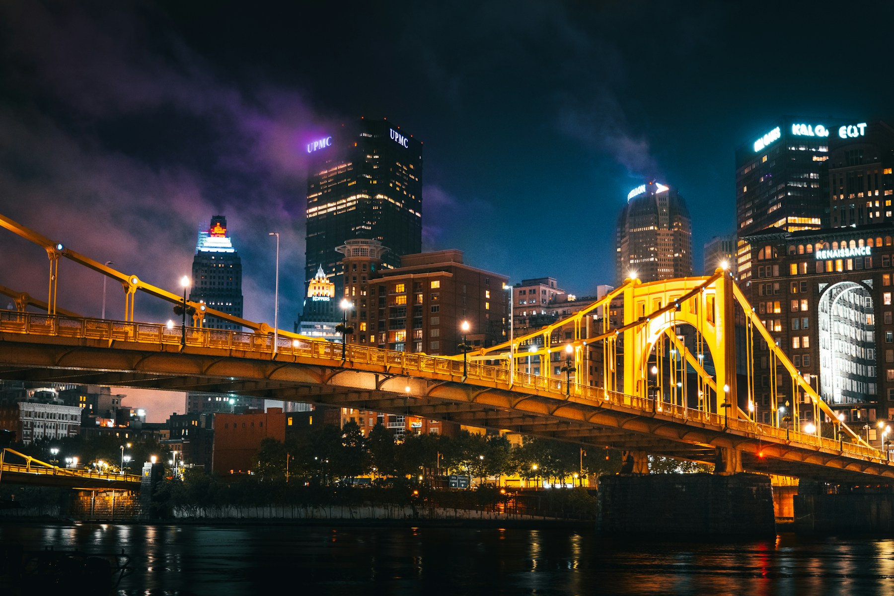 Pittsburgh skyline and an illuminated yellow bridge over the Allegheny River